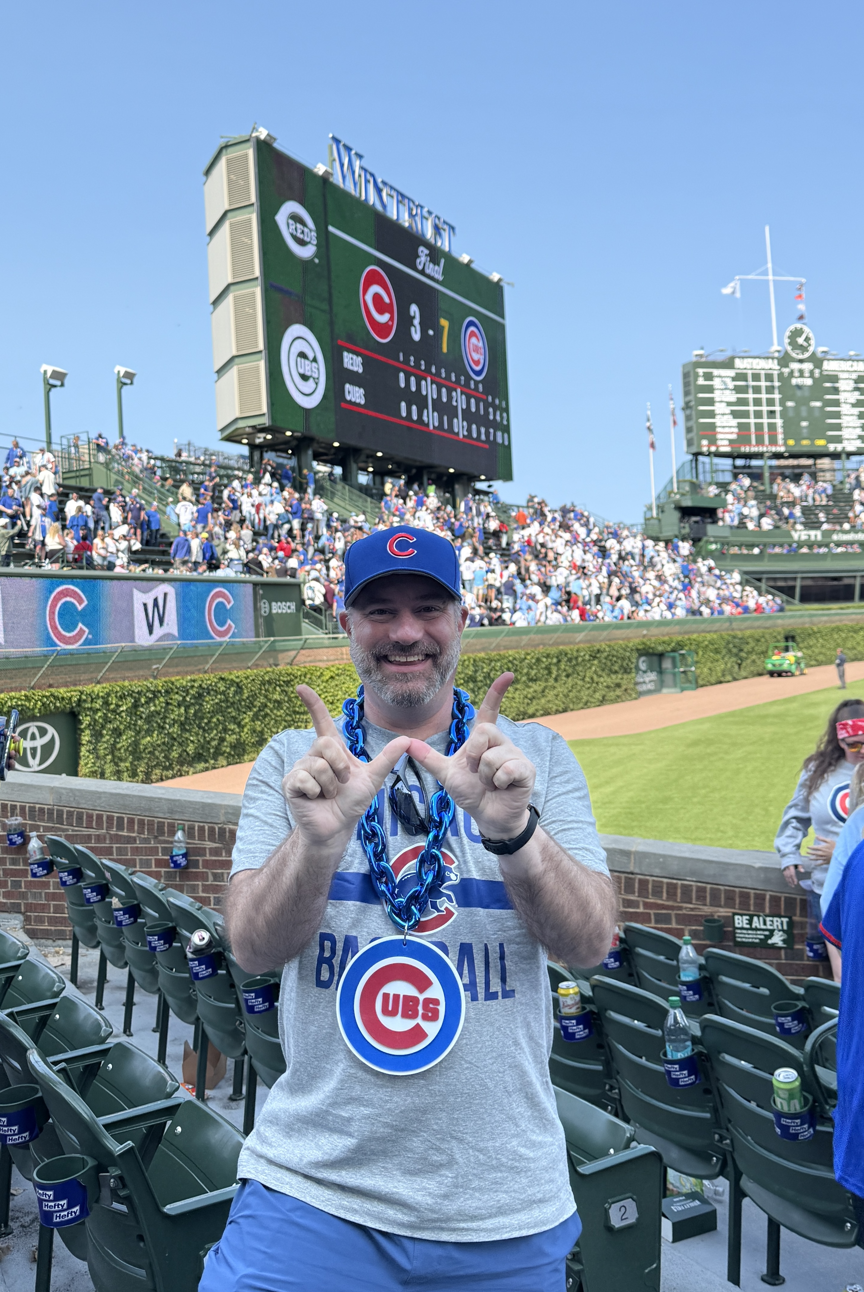 Matt celebrating in the stands during a Chicago Cubs game at Wrigley Field