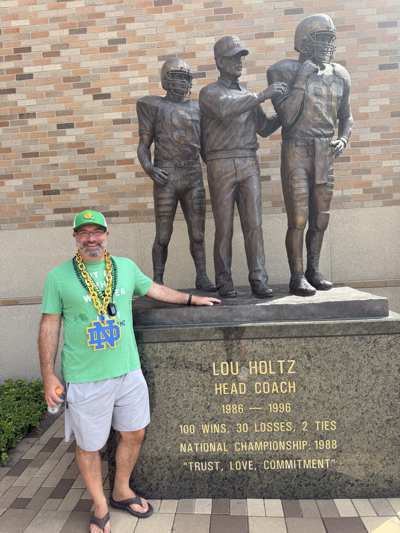 Matthew Owen beside the Lou Holtz statue on the Notre Dame campus