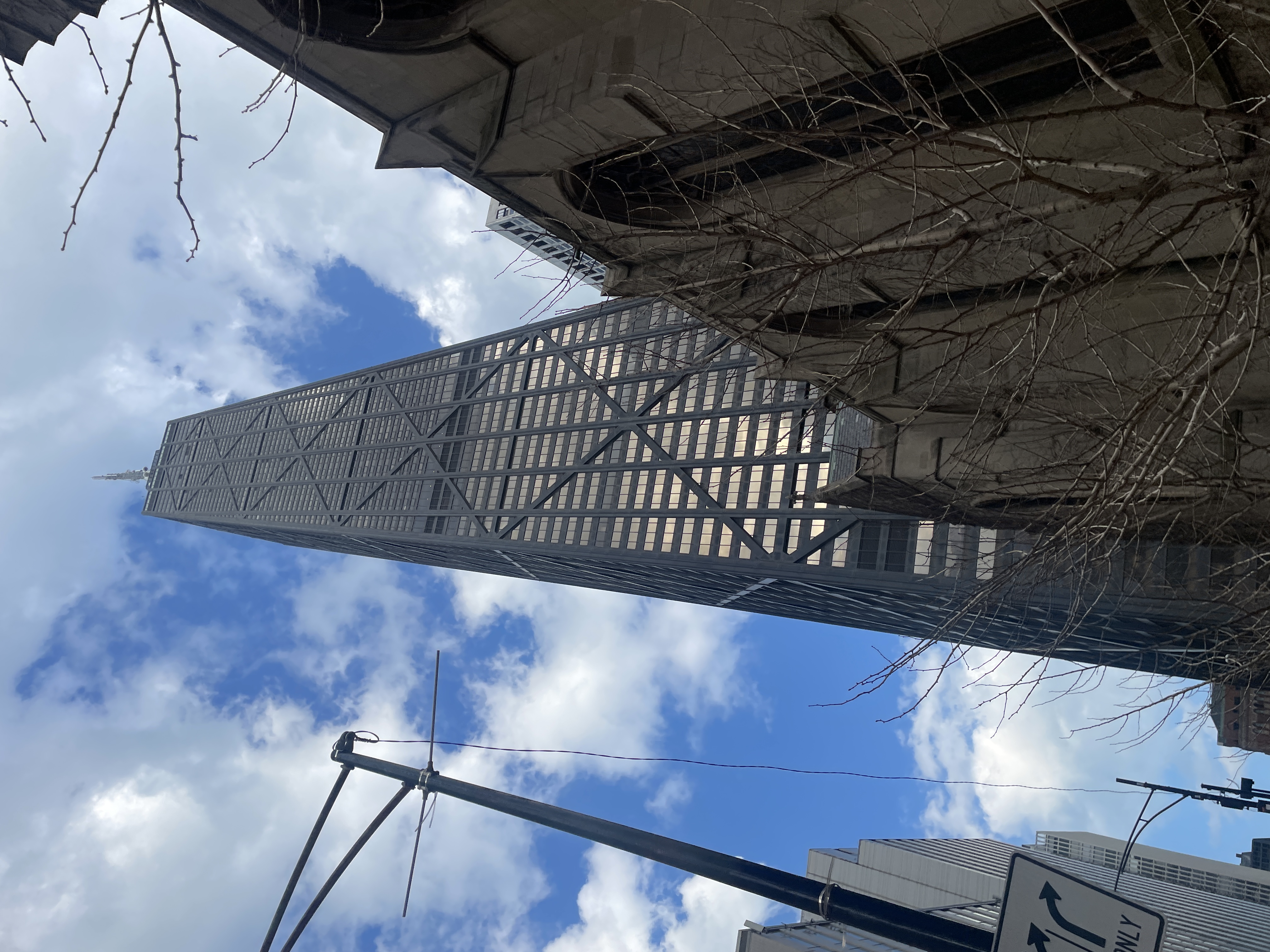The tower at 875 North Michigan Avenue rising above historic architecture in Chicago