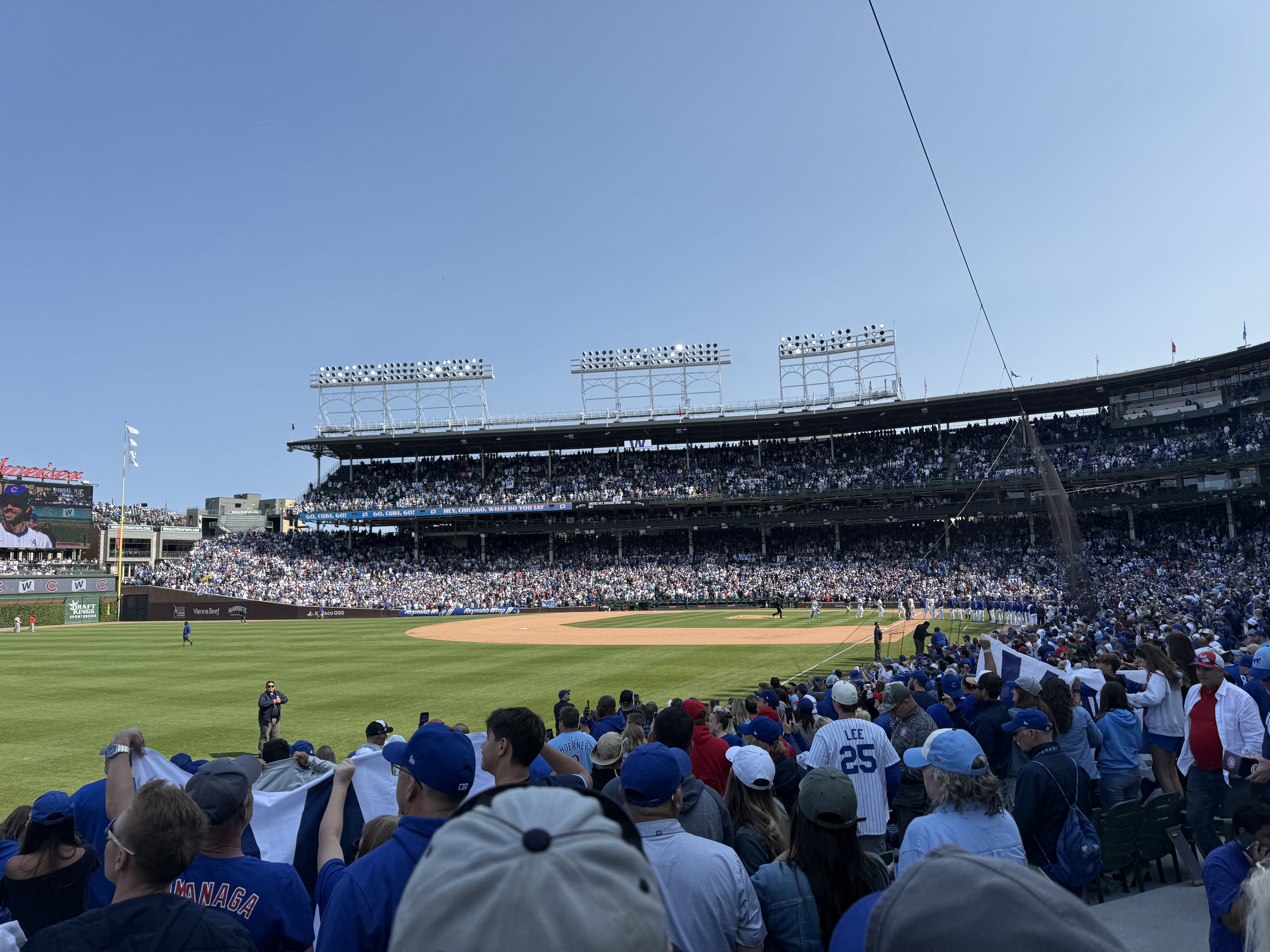 A full crowd watching a Chicago Cubs game at Wrigley Field