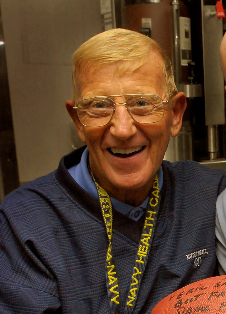 Lou Holtz smiling during a 2007 visit aboard the USS Abraham Lincoln