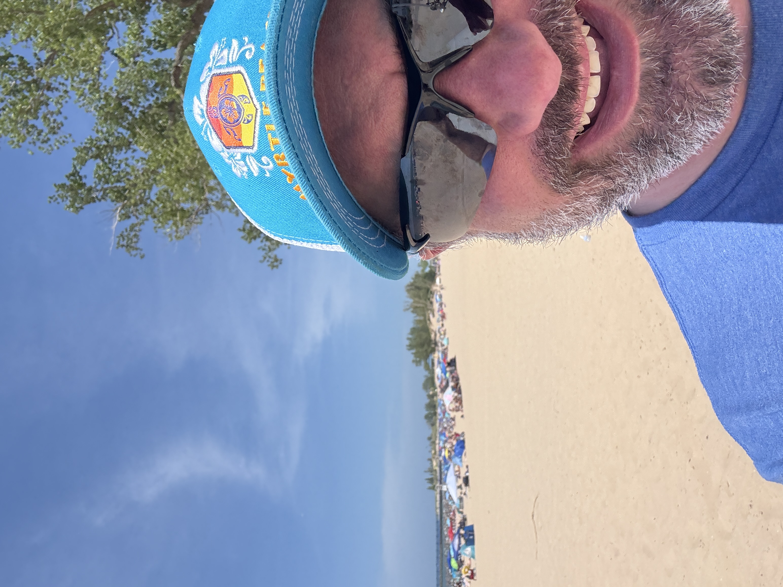 Matt smiling at Silver Beach with the Lake Michigan beach behind him