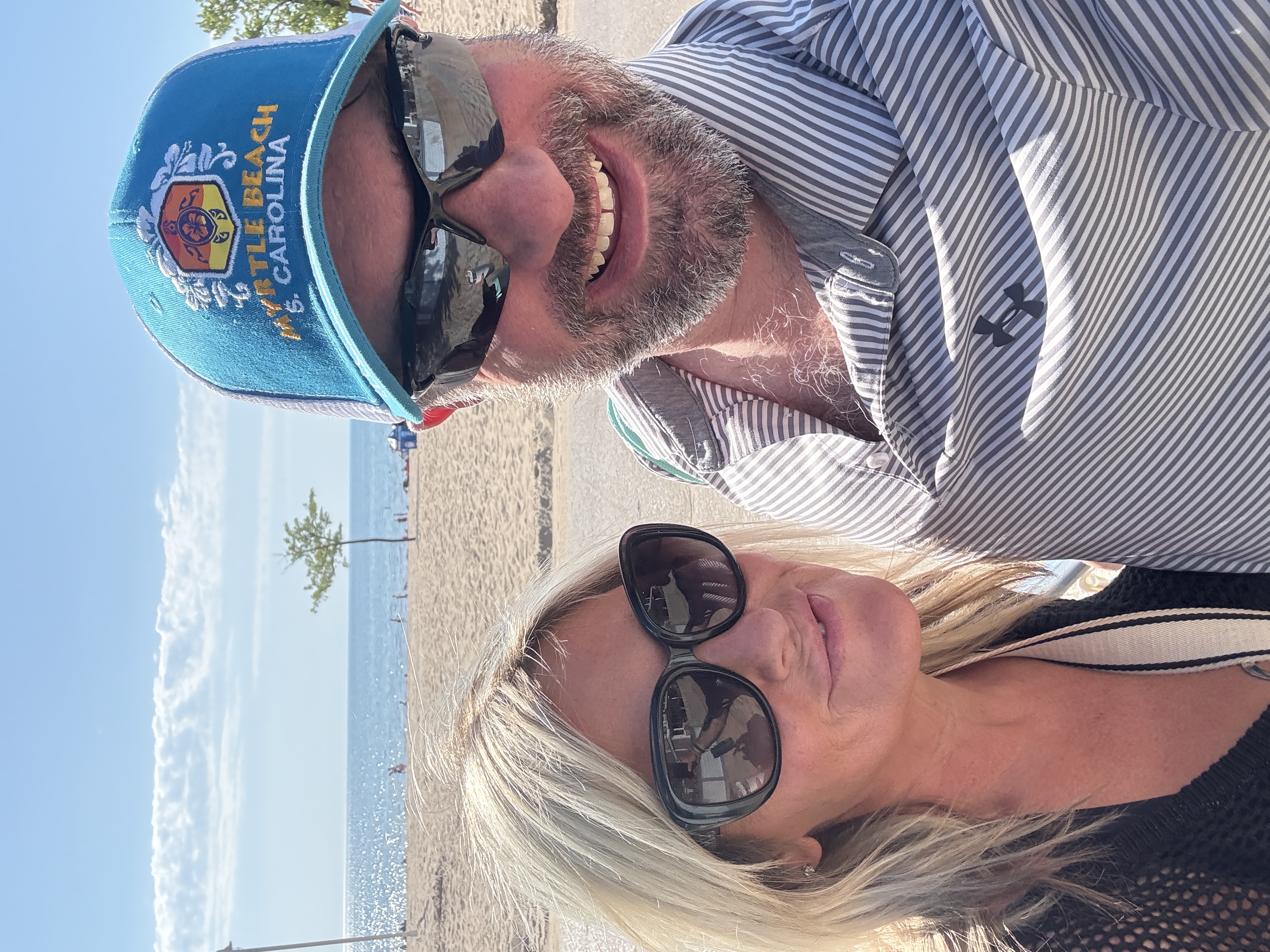 A couple smiling together beside Lake Michigan at Silver Beach